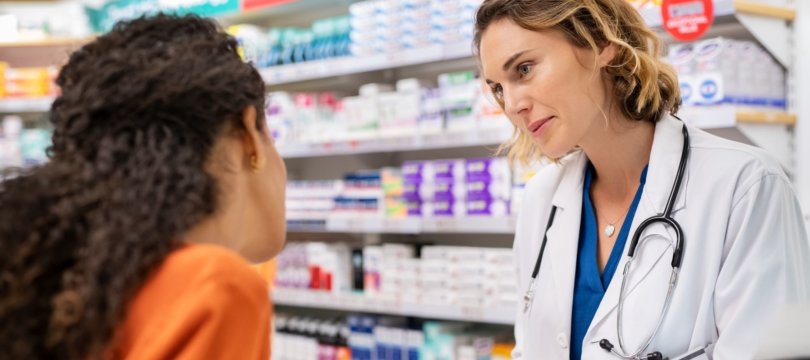Health Pharmacist Talking To Young Black Woman Wide Web Size